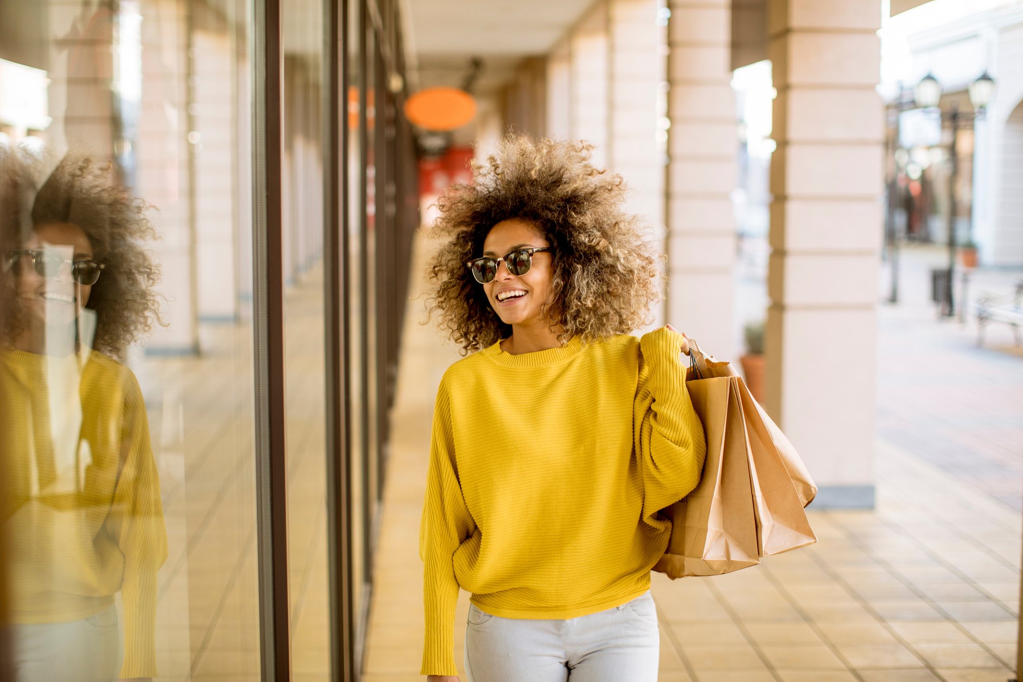 Young Black Woman with Curly Hair in Shopping